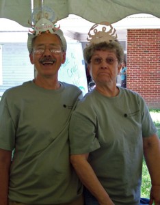 Photo of two volunteers wearing homemade crab-hats