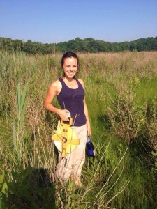 Photo: SERC intern Dejeanne Doublet heads out to sample marsh elder, a plant that in some zones coped surprisingly well with the harsh winter. (Credit Megan Palmer)