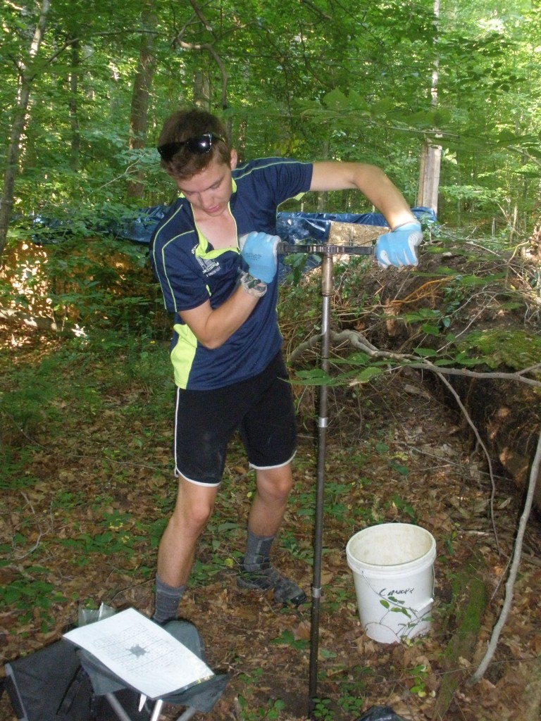 James Biddle, SERC intern, twists a soil augur into the ground to collect a 50 to 100 cm deep soil core.
