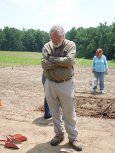 Jim Gibb stands at soil excavation