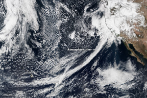 A big band of clouds stretches from Hawaii to the western coast of North America.