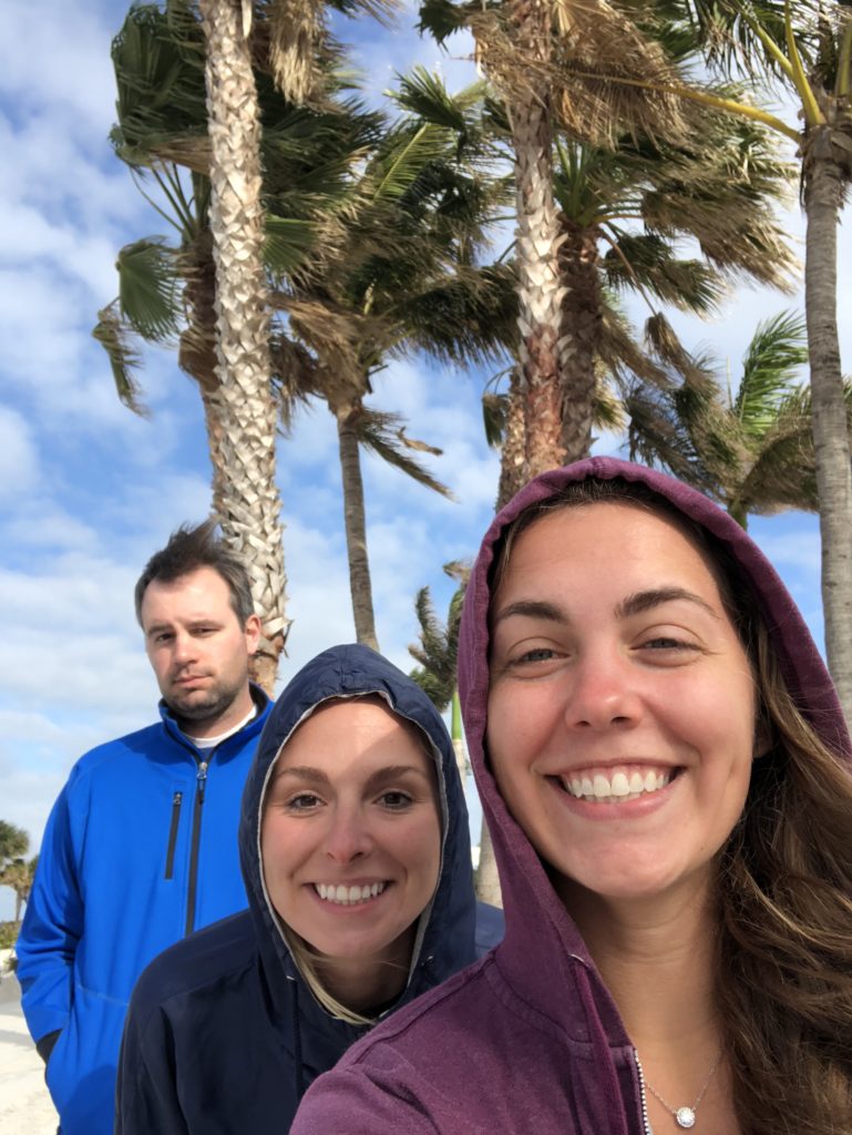 Selfie of three scientists with palm trees