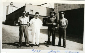 Black and white photo of four farm hands. Blue writing beneath photo: "1939 Java Farm"