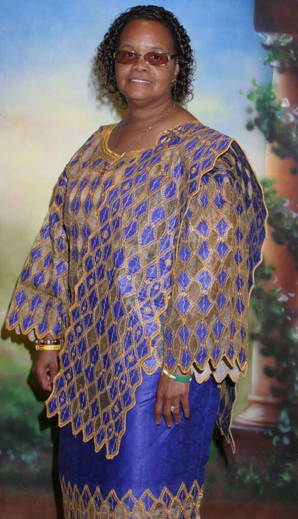 Black woman in a blue and gold African outfit